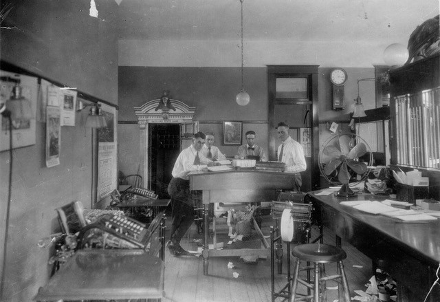 Group of men working at a bank during the early 1900s